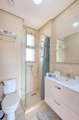 a bathroom with a toilet and a shower and a sink at New! Appt Moderne Jubaea avec parking & wifi in Marrakech