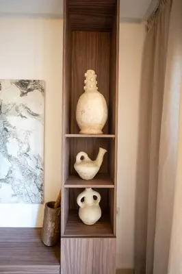 a book shelf with vases and vases on it at Hivernage by Louhou Collection in Marrakech