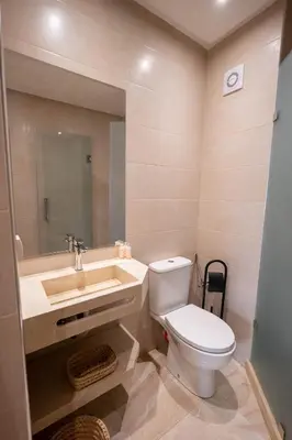 a bathroom with a toilet and a sink at Hivernage by Louhou Collection in Marrakech