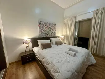 a bedroom with a large white bed with two pillows at Comfort and Charm in Marrakech 6 min from Gueliz in Marrakech