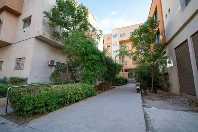 an empty sidewalk in front of a building at Comfort and Charm in Marrakech 6 min from Gueliz in Marrakech