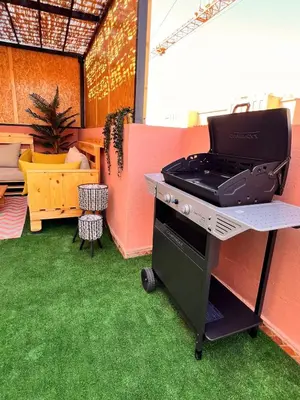 a grill on a table in a room with grass at Welcome to Chya House! in Marrakech