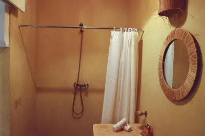 a bathroom with a shower and a mirror at Riad Chez moi in Marrakech