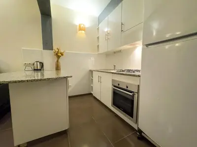 a kitchen with white cabinets and a refrigerator at Gueliz Marrakech Private 2BR Apartment with Pool and Parking in Marrakech