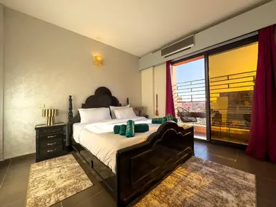 a bedroom with a large bed and a large window at Gueliz Marrakech Private 2BR Apartment with Pool and Parking in Marrakech