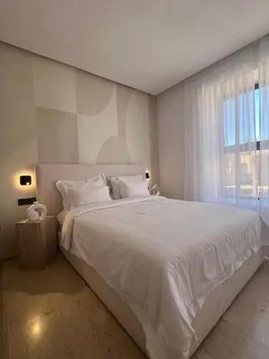 a bedroom with a large white bed with a window at Dar Zohra in Marrakech