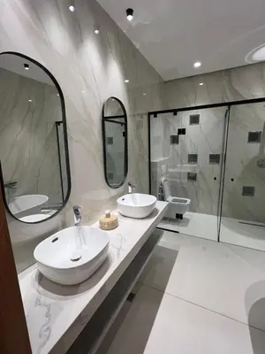 a bathroom with two sinks and a shower at Dar Zohra in Marrakech