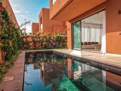 a swimming pool in the backyard of a house at Dar Zohra in Marrakech