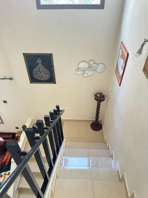a staircase in a house with a bunch of chairs at Charming and Comfortable Room Near Marrakech Airport in Marrakech
