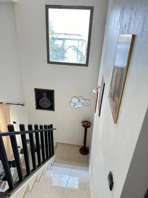 a staircase in a house with a window at Charming and Comfortable Room Near Marrakech Airport in Marrakech