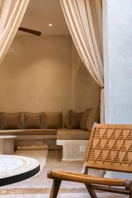 a living room with a couch and a chair at Riad Manah Marrakech - Ideal for groups & families in Marrakech