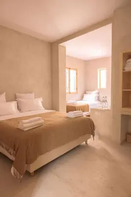 a bedroom with two beds and a large window at Riad Manah Marrakech - Ideal for groups & families in Marrakech