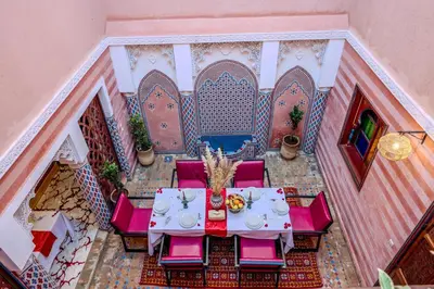 an overhead view of a table and chairs in a courtyard at Riad Le Graff Pink group in Marrakech