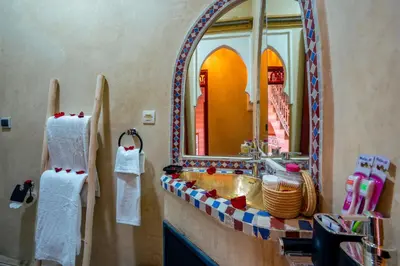 a bathroom with a sink and a mirror at Riad Le Graff Pink group in Marrakech