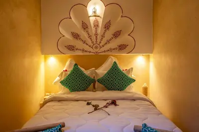 a bedroom with a large bed with green and white pillows at Riad Le Graff Pink group in Marrakech