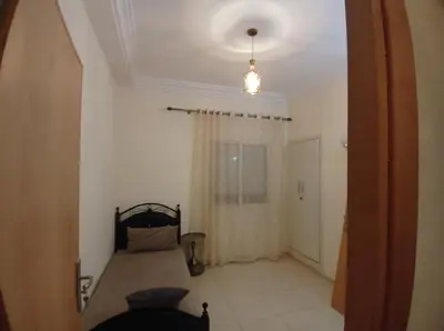 a bedroom with a bed in a room with a ceiling at Horizon Sérénité in Marrakech