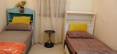 a small bedroom with two beds and a window at Horizon Sérénité in Marrakech