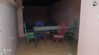 a room with a table and colorful chairs at Horizon Sérénité in Marrakech
