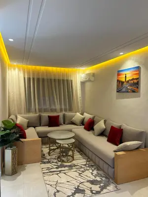a living room with a couch and a table at Apparently 2 bedrooms- baby equipment in Marrakech