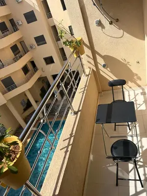 a balcony of a building with a swimming pool at Apparently 2 bedrooms- baby equipment in Marrakech
