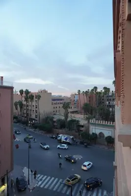 a city street with cars parked in a parking lot at Maison Nadia in Marrakech