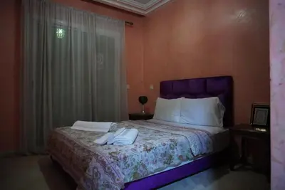 a bedroom with a bed with two towels on it at Maison Nadia in Marrakech
