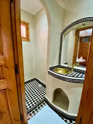 a bathroom with a sink and a mirror at Riad Rose Mati in Marrakech