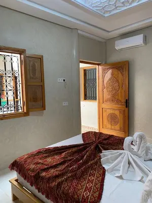 a bedroom with a bed with towels on it at Riad Rose Mati in Marrakech