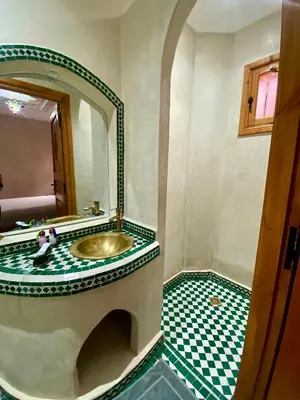 a bathroom with a sink and a mirror at Riad Rose Mati in Marrakech