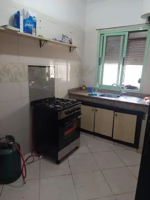 a kitchen with a stove and a sink at Bassatine gueliz 2 in Marrakech