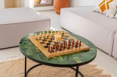 a chess board on a glass table with a candle at Perfect Villa, Heated Pool, 15min from City Center, 4 Bedrooms, Private Cook and Airport Pickup in Marrakech