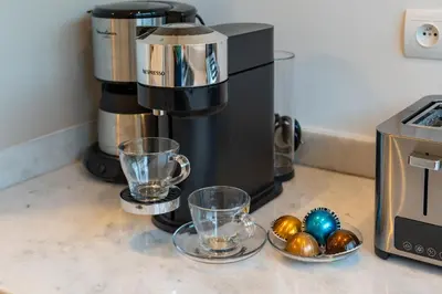 a coffee maker and two cups and balls on a counter at Perfect Villa, Heated Pool, 15min from City Center, 4 Bedrooms, Private Cook and Airport Pickup in Marrakech