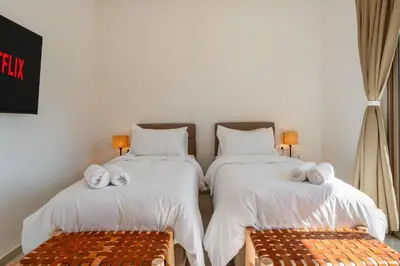 a bedroom with two beds with towels on them at Perfect Villa, Heated Pool, 15min from City Center, 4 Bedrooms, Private Cook and Airport Pickup in Marrakech
