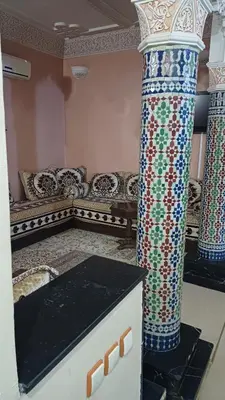 a living room with two columns and a couch at Marrakech Maroc Guiliz in Marrakech