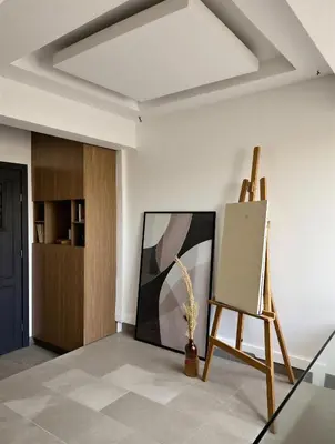 an empty room with an easel and a painting on a wall at Bohemian Chic Duplex Marrakech in Marrakech