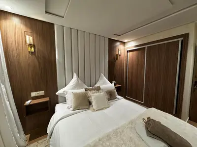 a bedroom with a large bed with white sheets and pillows at Duplexe super in Marrakech