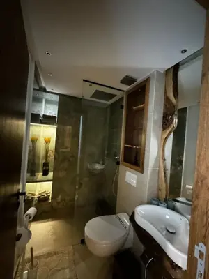a bathroom with a toilet and a sink at Duplexe super in Marrakech
