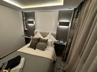 a bedroom with a bed with pillows on it at Duplexe super in Marrakech