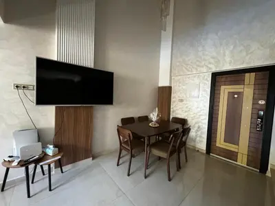 a dining room with a table and a television on the wall at Duplexe super in Marrakech
