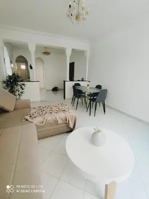a living room with a couch and a table at Top Location Gueliz Centre in Marrakech