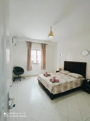a bedroom with a bed and a chair in it at Top Location Gueliz Centre in Marrakech