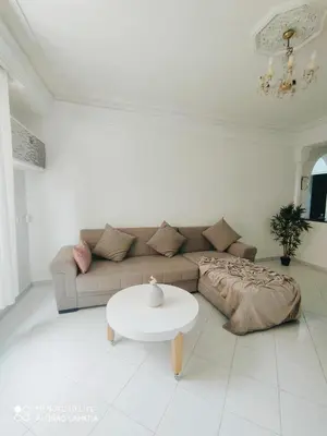 a living room with a couch and a table at Top Location Gueliz Centre in Marrakech