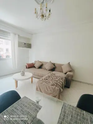 a living room with a couch and a table at Top Location Gueliz Centre in Marrakech