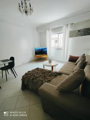 a living room with a couch and a table at Top Location Gueliz Centre in Marrakech
