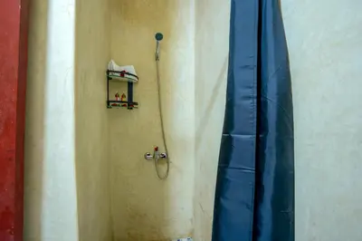 a bathroom with a shower with a shower curtain at Riad Le Graff Pink in Marrakech