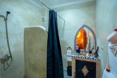 a bathroom with a shower and a mirror at Riad Le Graff Pink in Marrakech