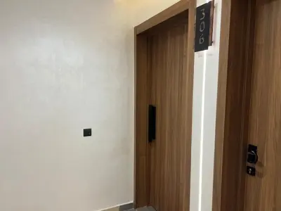 a hallway with a door with a sign on it at Design Calme Luxe Fibre Ultra-Rapide 2CH in Marrakech