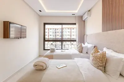 a hotel room with two beds and a television at Design Calme Luxe Fibre Ultra-Rapide 2CH in Marrakech