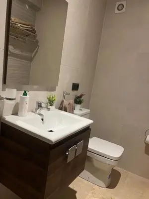 a bathroom with a sink and a toilet and a mirror at Cozy Apartment With Pool 5 min from Guéliz in Marrakech
