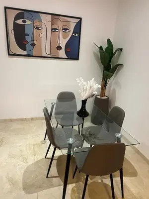 a dining room with a glass table and chairs at Cozy Apartment With Pool 5 min from Guéliz in Marrakech